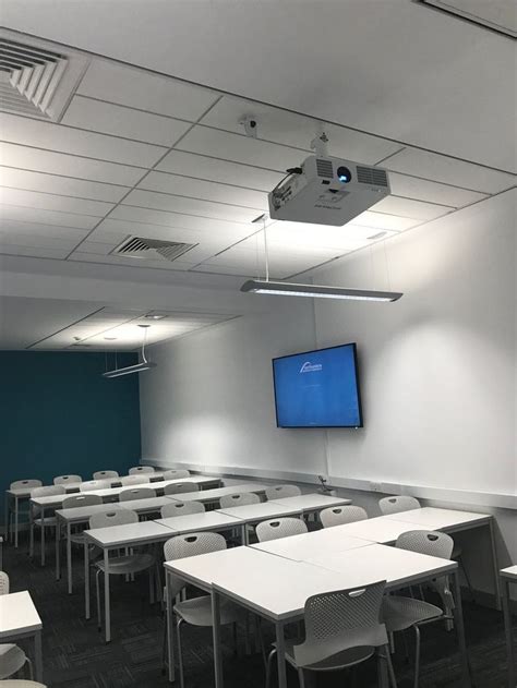 A HITACHI projector mounted to the ceiling in a classroom. Projector Setup, Projector Mount ...