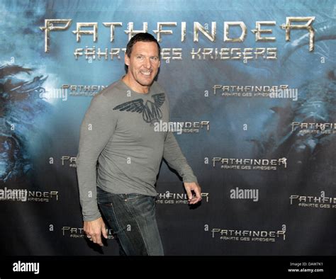 German actor Ralf Moeller poses in front of a film poster for his new ...