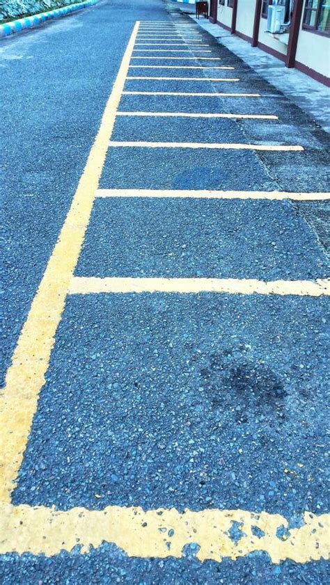 Empty parking space for motorbikes and bicycles with yellow lines ...