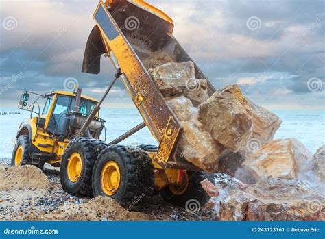 Dump Truck Unloading Large Rocks To Reinforce a Stock Image - Image of industry, action: 243123161