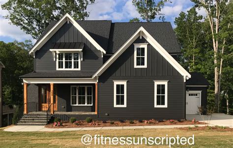 a gray house with white trim and windows