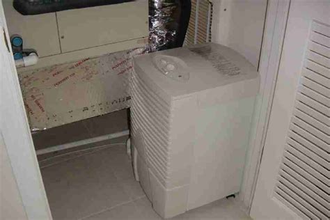 Photo of a stand-alone dehumidifier in a closet with a louvered door Dehumidifiers, Relative ...