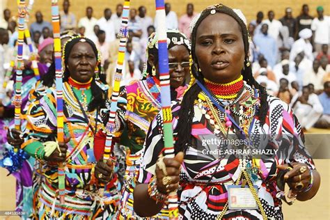 Members of Sudan's Nuba community perform a traditional dance during ...