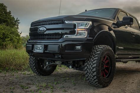 front grill of a lifted 2018 diesel ford f150 lariat in black with pro comp 6 in lift kit and ...