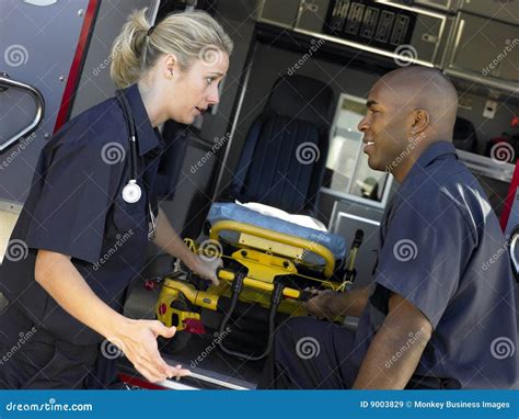 Two Paramedics Removing Gurney from Ambulance Stock Image - Image of adult, american: 9003829