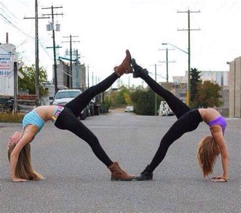 two women doing handstands in the street