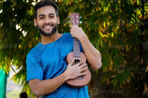 boy with ukulele a musical instrument Handsome Indian musician image 6783847 Stock Photo at Vecteezy