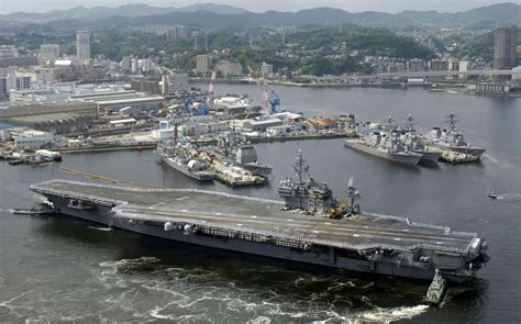 The USS Kitty Hawk (CV-63) being pushed into dock I think In Yokosuka ...