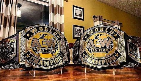 A clear picture of the AEW World Tag Team Championship belts as introduced by Kevin Smith, Jason ...