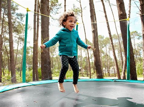 Child Jumping On Trampoline