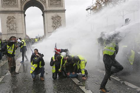 French police clash with protesters in Paris riot; 90 injured - CBS News