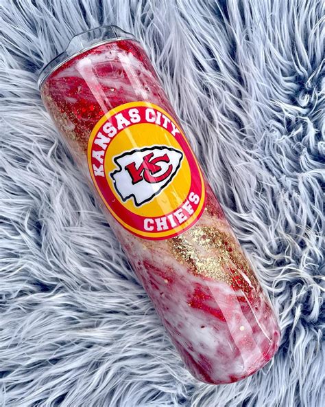 the kansas chiefs logo is painted on a red and gold tube wrapped in glitters