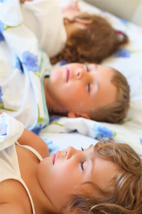 Children Three Together Sleeping On Bed Stock Photo - Image: 13021868