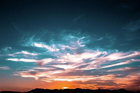 Light from the setting sun illuminating the sky and clouds Photograph by Artpics - Pixels