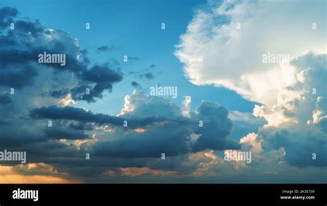 Cumulus fluffy sunset clouds sky background Stock Photo - Alamy