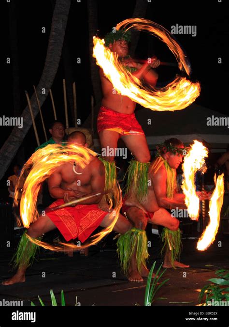 Traditional Hawaiian fire dance performed by three mail dancers Stock ...