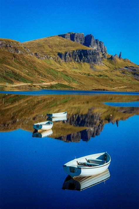 Storr Lochs and the Trotternish Ridge on the Isle of Skye , on a very still morning . Scottish ...