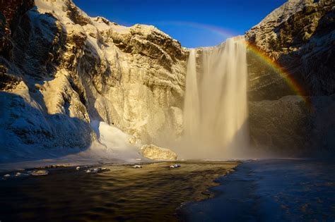 Perfect Skógafoss - waterfall covered in snow, no wind, rainbow ...