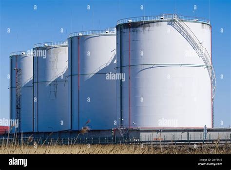 Fuel and lng gas storage tanks at oil terminal Stock Photo - Alamy