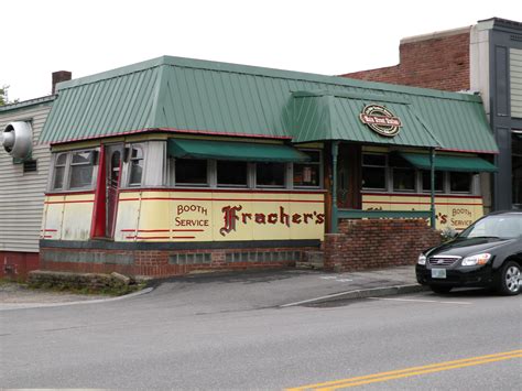 a car parked in front of a small restaurant