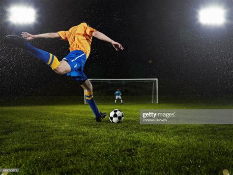 Professional soccer player about to strike penalty kick goalkeeper in ...