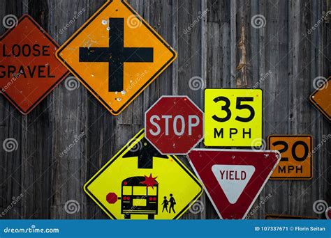 Collection of Various Road Signs on Rustic Wooden Wall Stock Image - Image of shape, hanging ...