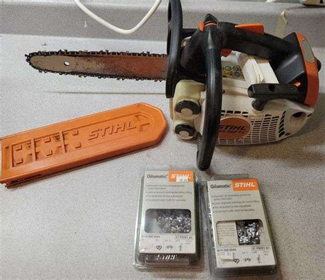 Stihl 12" gas powered chainsaw and extra chains - Sherwood Auctions