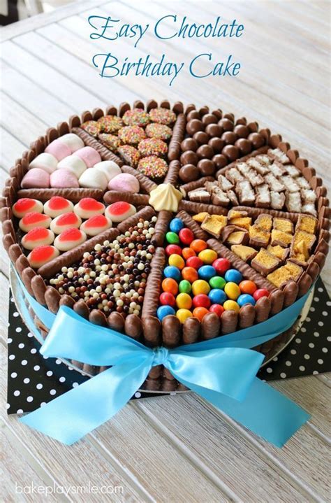 An easy chocolate birthday cake decorated with chocolate biscuits, lollies, marshmallows and ...