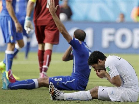 Suarez banned for nine matches and four months over biting incident