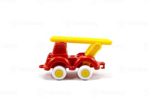 Red paint plastic toy fire truck with yellow ladder isolated on white ...