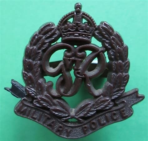 A WWII PLASTIC MILITARY POLICE CAP BADGE