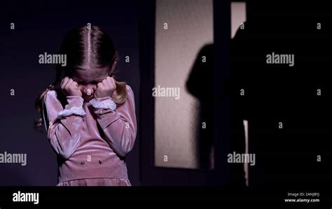 Terrified child closing eyes scary criminal silhouette entering room, kidnapping Stock Photo - Alamy