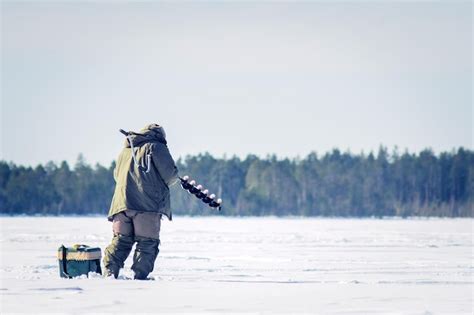 Premium Photo | Fishermen in the winter for ice fishing