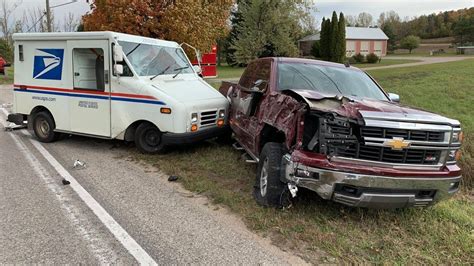 Postal vehicle hit by pickup truck while delivering mail