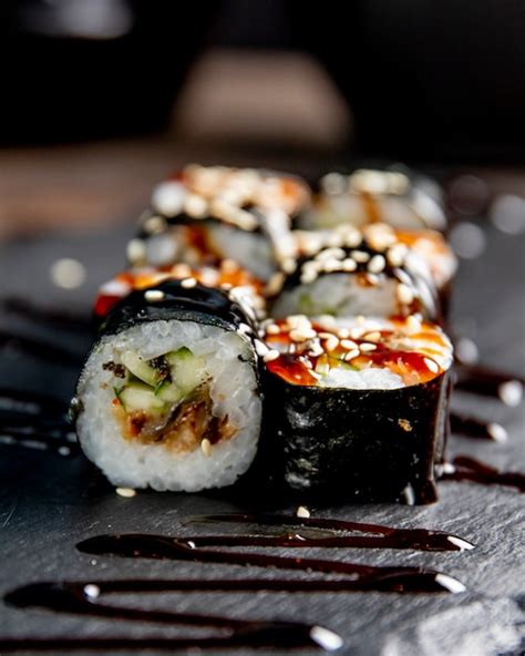 Free Photo | Maki roll with cucumber served with sauce and sesame seeds