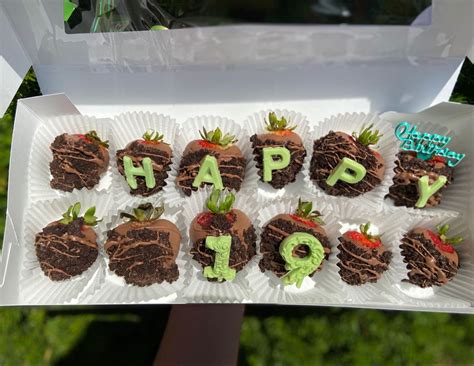 chocolate covered strawberries with the words happy on them