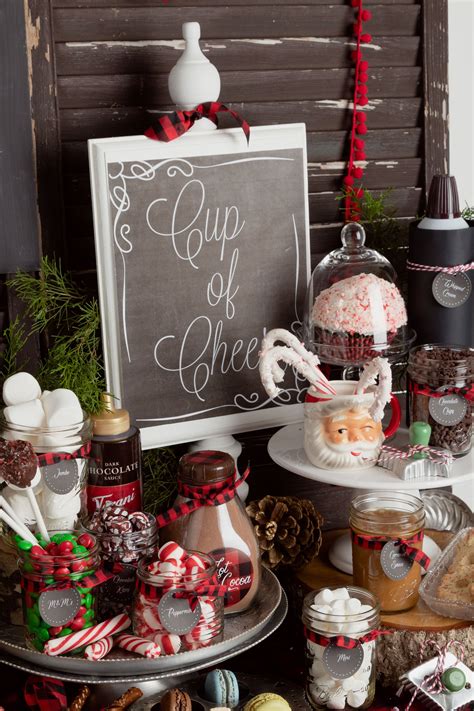 a table topped with lots of different types of food and candys next to a sign that says cup of cheer