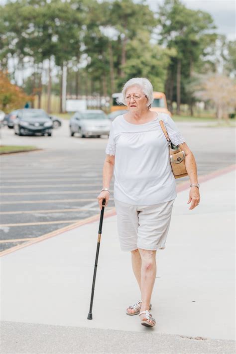 Elderly woman walking with a cane - Sage Rehabilitation Hospital