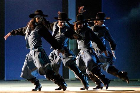 a group of people that are standing in the middle of a dance pose on stage