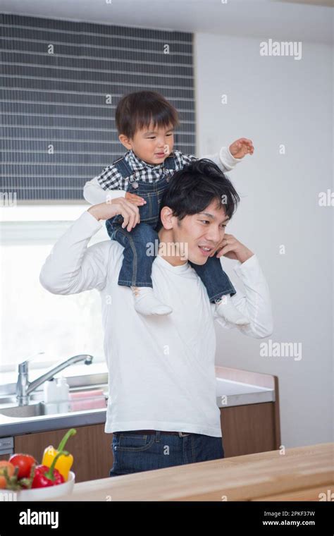 Man carrying a child on his shoulders Stock Photo - Alamy