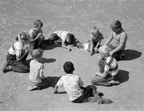 Children playing marbles in a playground, 1950s. : TheWayWeWere