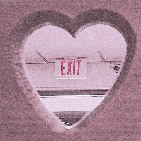 a heart shaped window with an exit sign in the middle