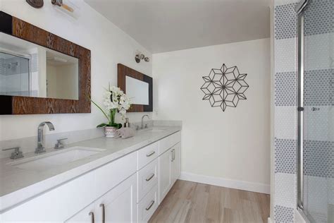 COASTAL BATHS We love our client’s choice of mirrors. The hexagonal mirrors frame the master ...