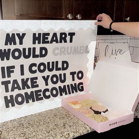 someone holding up a sign that says, my heart would crumb if i could take you to home coming