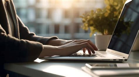 Premium AI Image | A person typing on a laptop at a wooden desk in a home office