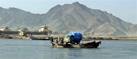 Local residents ride a ferry across the Kabul River in Afghanistan, Dec. 6, 2010. U.S. Marines ...