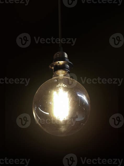 Glowing light bulb on dark background 8614327 Stock Photo at Vecteezy