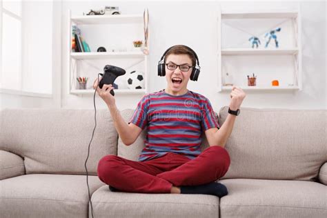 Excited Teenage Boy Playing Video Game at Home Stock Image - Image of ...