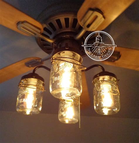 three mason jar lights hanging from a ceiling fan