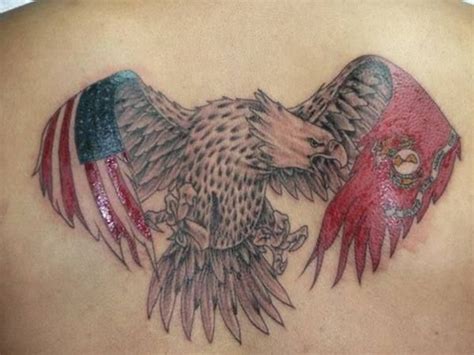 an eagle and flag tattoo on the back of a man